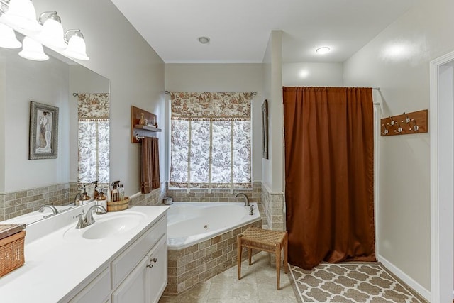 bathroom featuring tile patterned flooring, vanity, and a relaxing tiled tub