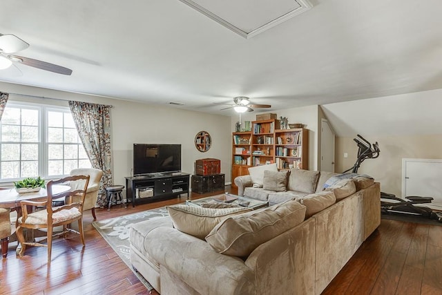 living room with dark hardwood / wood-style flooring and ceiling fan