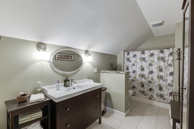 bathroom with tile patterned floors, lofted ceiling, toilet, and vanity