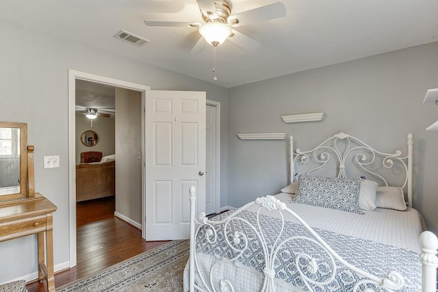 bedroom with ceiling fan and dark hardwood / wood-style floors