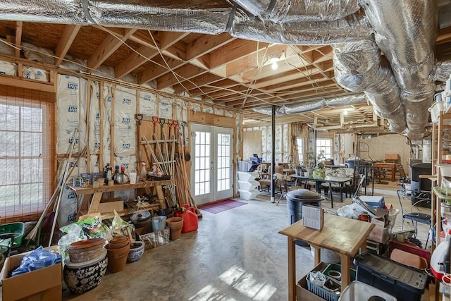 miscellaneous room featuring french doors, plenty of natural light, and concrete flooring