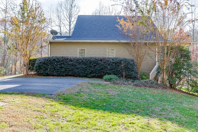 view of property exterior with a yard