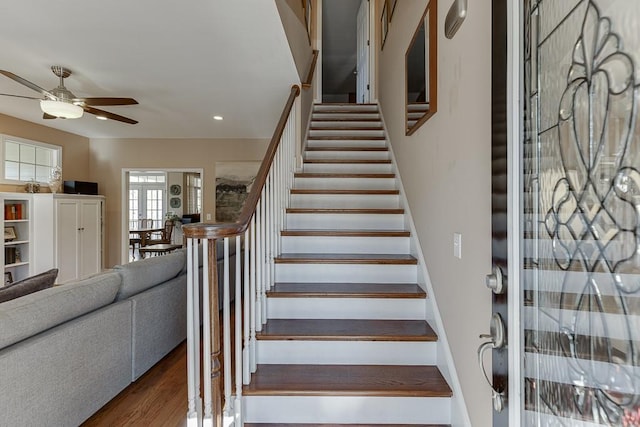 stairway featuring hardwood / wood-style floors and ceiling fan