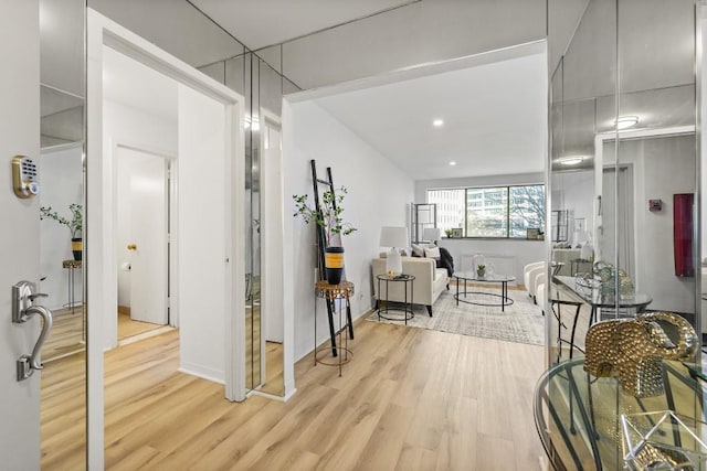 hallway with light hardwood / wood-style floors