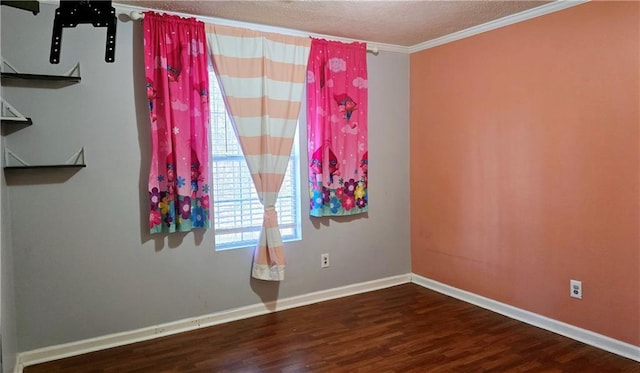 empty room featuring hardwood / wood-style floors, crown molding, and a textured ceiling