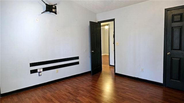 unfurnished bedroom featuring dark hardwood / wood-style floors