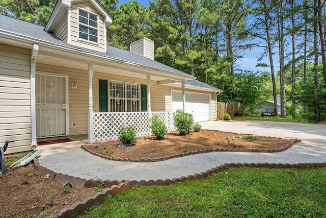 exterior space with a garage and covered porch