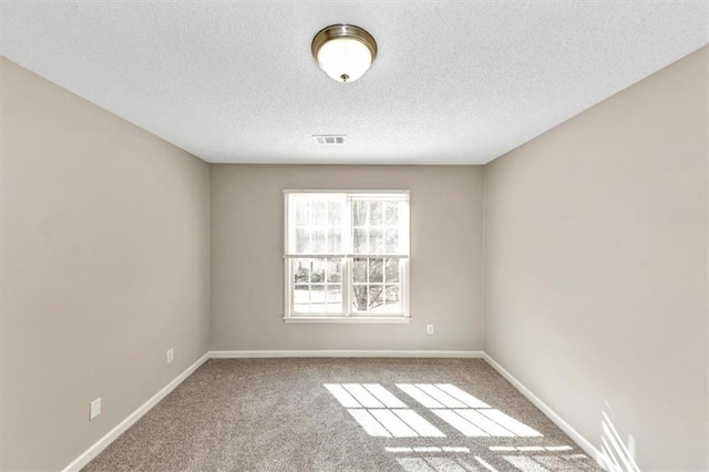 spare room featuring carpet floors and a textured ceiling