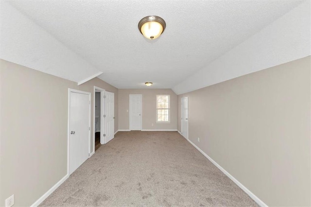 carpeted empty room featuring a textured ceiling