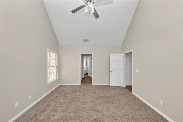 unfurnished bedroom with ceiling fan, light carpet, and high vaulted ceiling