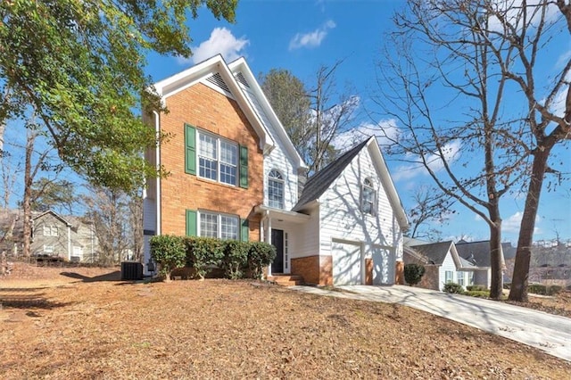 view of front of home featuring a garage and central air condition unit