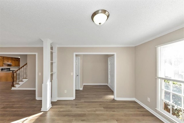 interior space with ornamental molding, dark hardwood / wood-style floors, and a textured ceiling