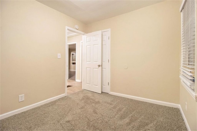 1907 Oak Valley Rd, Decatur, GA 30035 - unfurnished bedroom with baseboards and light carpet