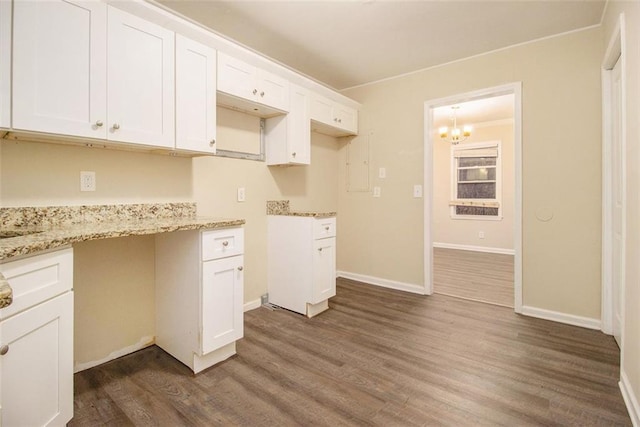 1907 Oak Valley Rd, Decatur, GA 30035 - kitchen with white cabinets, baseboards, a notable chandelier, light stone counters, and dark wood-type flooring
