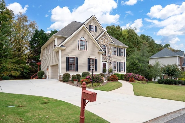 view of front facade with a garage and a front yard