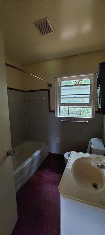 2980 Wanda Cir SW, Atlanta, GA 30315 - bathroom with toilet, vanity, shower / washtub combination, and tile walls