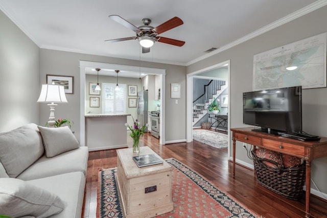 living room with crown molding, ceiling fan, and dark hardwood / wood-style flooring