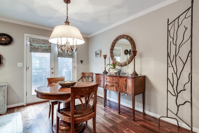 dining room featuring ornamental molding, dark wood-type flooring, and a notable chandelier