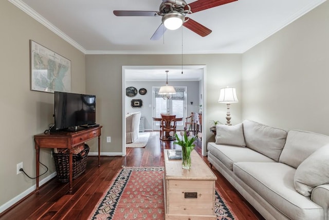 living room with dark wood-type flooring, ornamental molding, and ceiling fan