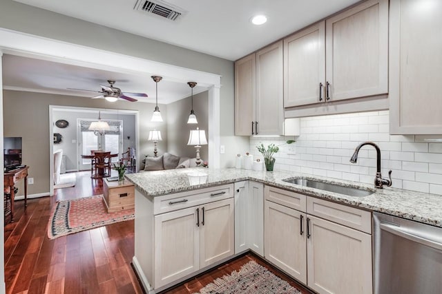 kitchen featuring dark hardwood / wood-style floors, tasteful backsplash, dishwasher, sink, and kitchen peninsula