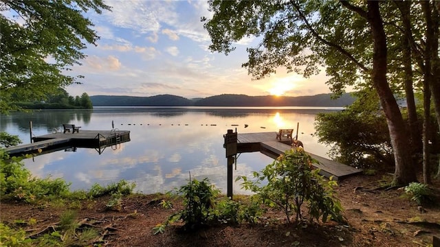 view of dock with a water and mountain view