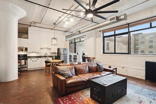 living room with ceiling fan and radiator heating unit