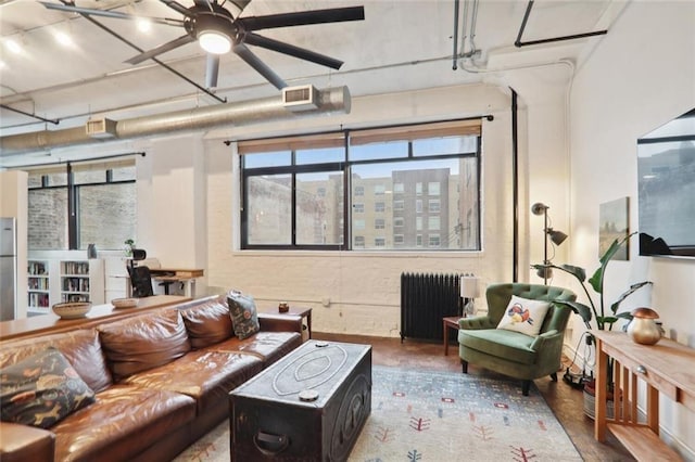 living room with ceiling fan and radiator heating unit