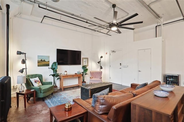 living room with concrete floors, wine cooler, and ceiling fan