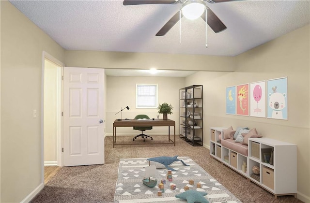 office area with light carpet, a textured ceiling, and ceiling fan