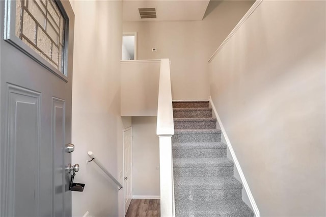 stairway featuring wood-type flooring