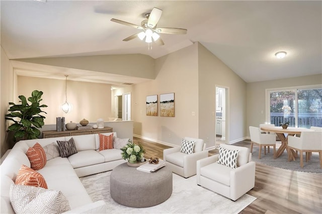 living room with ceiling fan, light hardwood / wood-style flooring, and high vaulted ceiling