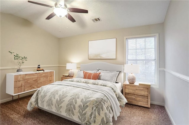 bedroom with vaulted ceiling, dark carpet, and ceiling fan