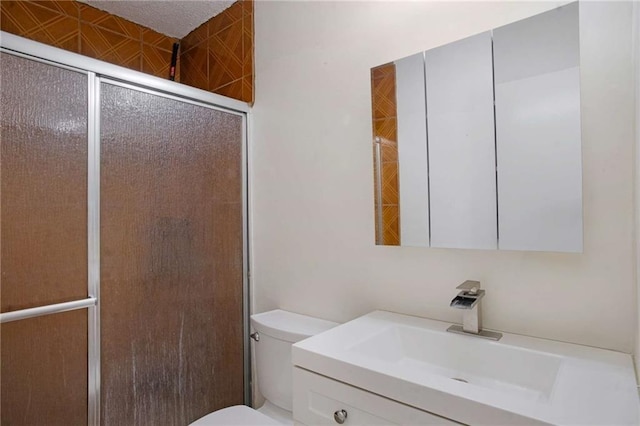 bathroom featuring vanity, toilet, and walk in shower