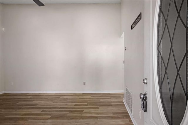 unfurnished room with hardwood / wood-style flooring