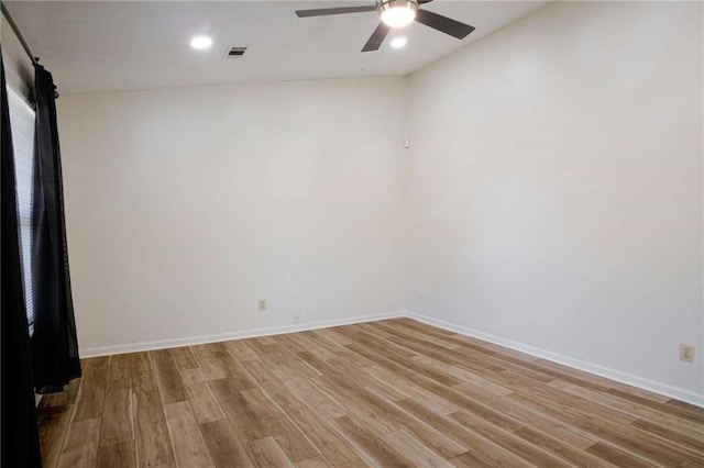 spare room with ceiling fan and light wood-type flooring