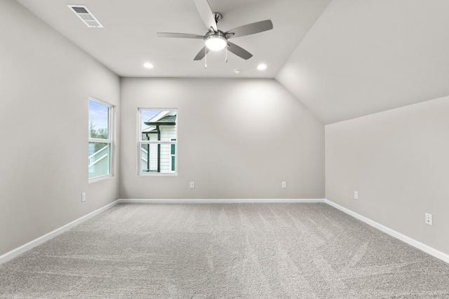 empty room with carpet, lofted ceiling, and ceiling fan