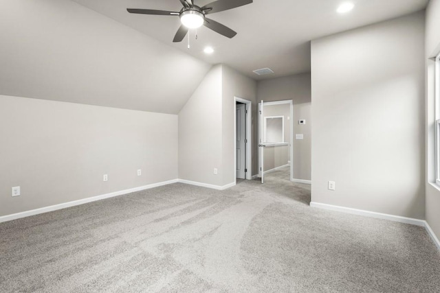 bonus room featuring ceiling fan, light colored carpet, and vaulted ceiling