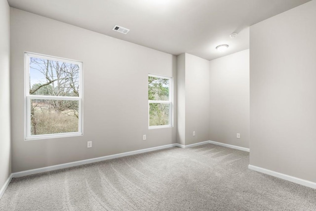 spare room with carpet and plenty of natural light