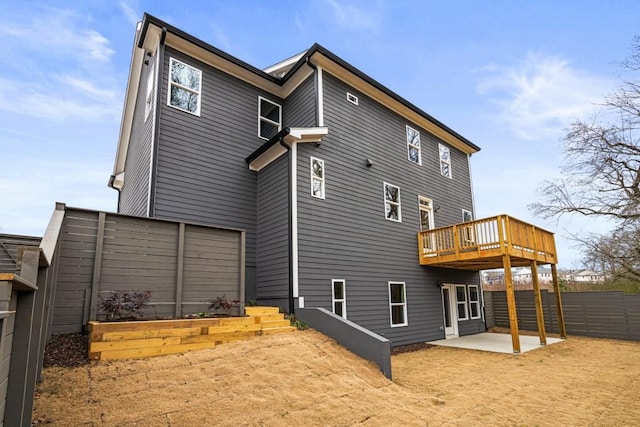 rear view of house featuring a patio and a deck