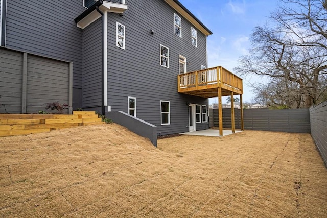 back of house with a patio and a deck