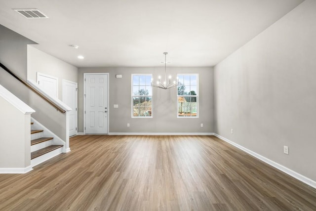 interior space with hardwood / wood-style floors and a chandelier