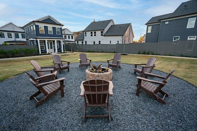 surrounding community with a yard and a fire pit