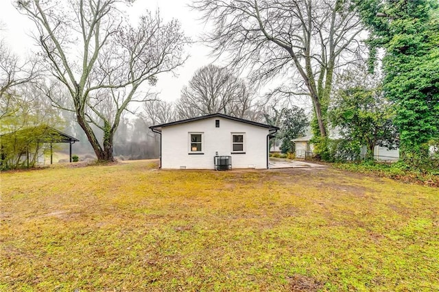 2162 Westover Dr, Atlanta, GA 30344 - rear view of property with a lawn and central AC unit