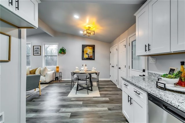 2162 Westover Dr, Atlanta, GA 30344 - kitchen with dishwasher, vaulted ceiling, dark wood finished floors, light stone countertops, and white cabinetry