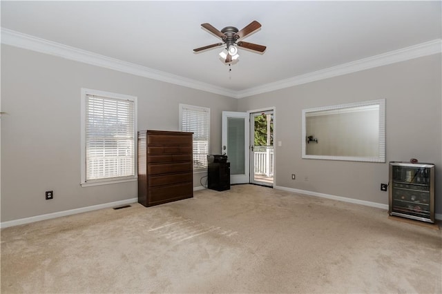 unfurnished bedroom featuring ornamental molding, multiple windows, and visible vents