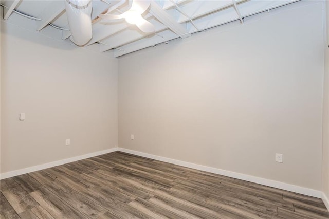 unfurnished room featuring baseboards and wood finished floors