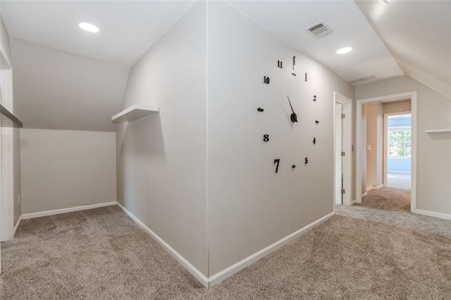 corridor with recessed lighting, light colored carpet, visible vents, vaulted ceiling, and baseboards