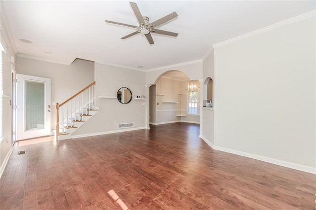 unfurnished living room featuring stairway, wood finished floors, visible vents, and crown molding