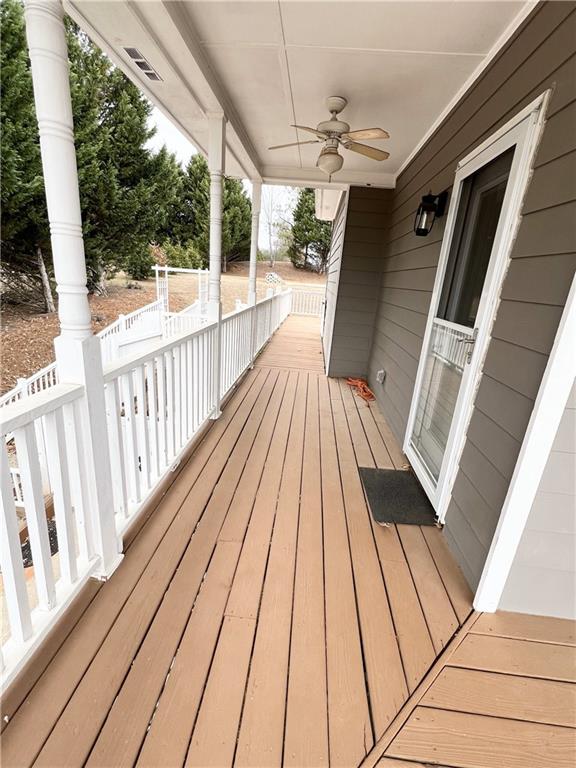 deck with a porch and a ceiling fan