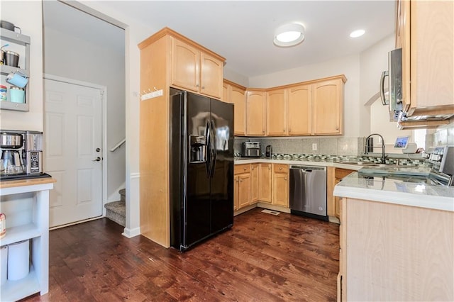 kitchen with light countertops, light brown cabinetry, appliances with stainless steel finishes, dark wood-type flooring, and a sink